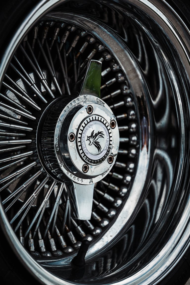 Detailed close-up of a shiny chrome vehicle wheel with intricate spokes.